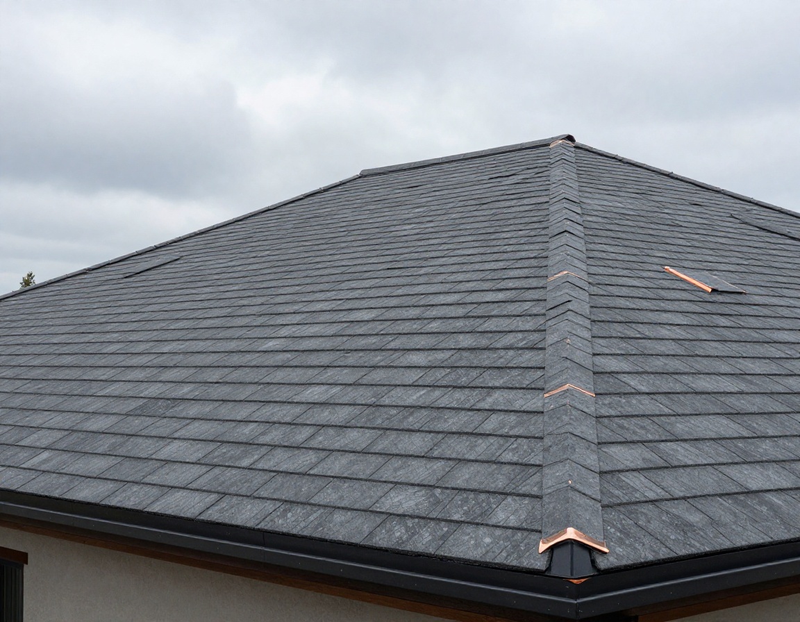 Engineered composite slate roof installed with custom copper flashing after restoration