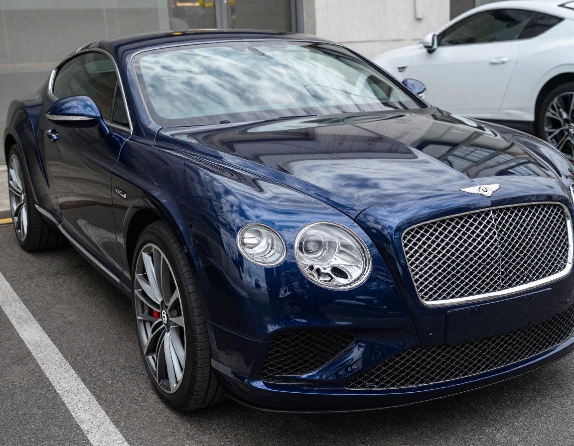 Bentley hood with glass-grade reflection under inspection lights